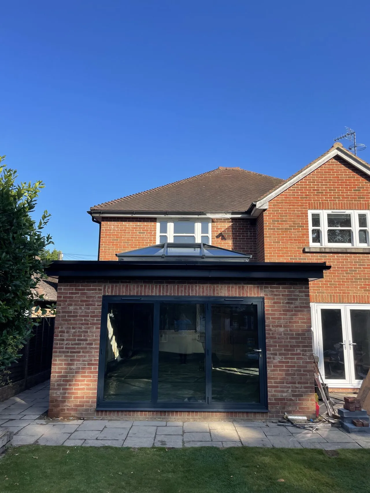A large brick house with a black roof.